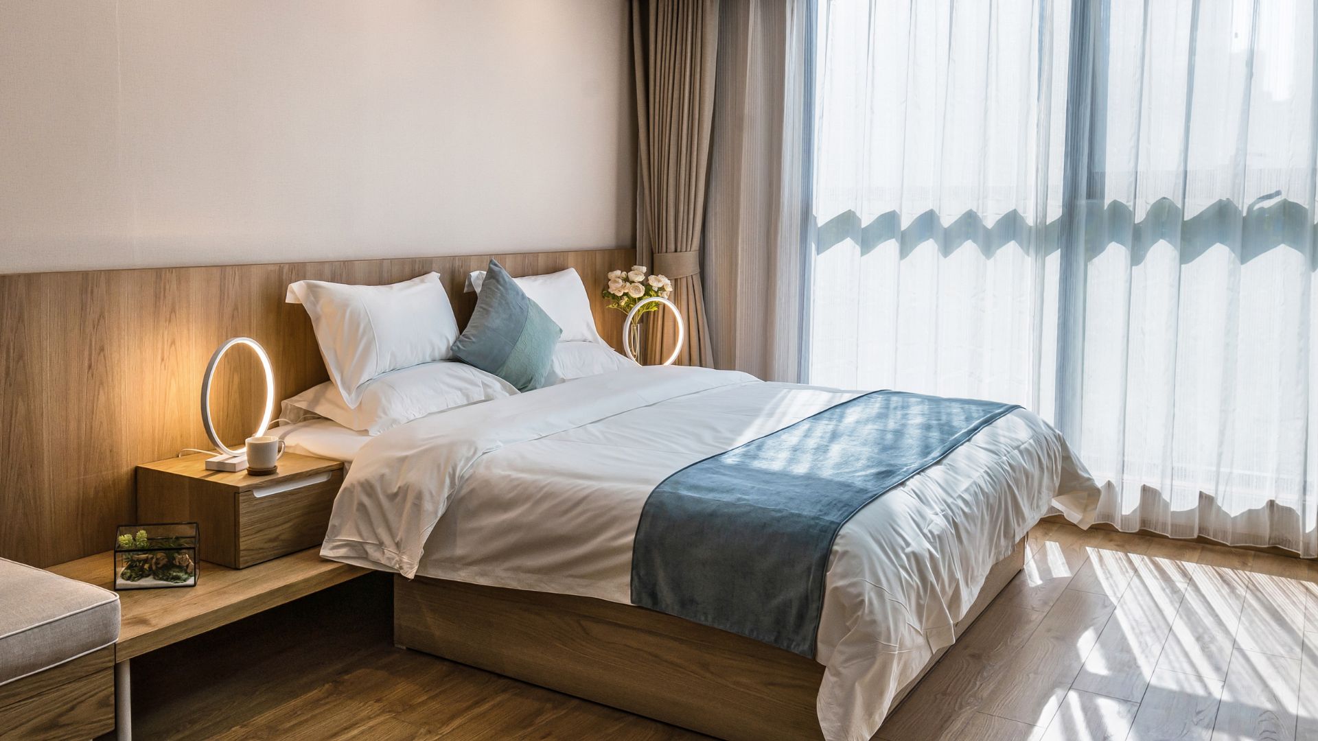 A bedroom with a large bed and a large window